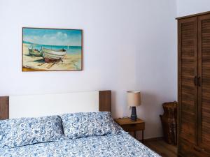 a bedroom with a bed and a painting on the wall at Apartment Stella in Vis