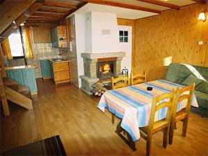 a living room with a table and a fireplace at Leśna Polana in Baligród