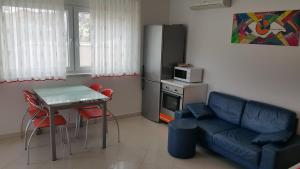salon z kanapą, stołem i kuchenką mikrofalową w obiekcie Apartment Onbria Sol w Medulinie +5 zdjęć