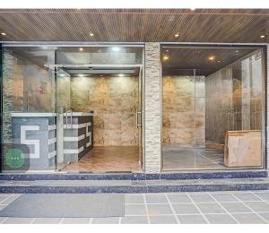 a glass door of a bathroom with a shower at Hotel sai laxmi residency in Lonavala