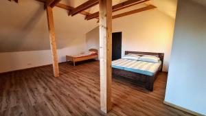 a bedroom with a bed and a wooden floor at Thomas home in Homole