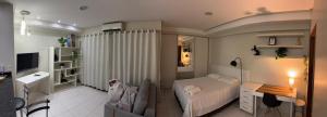 a bedroom with a bed and a desk and a television at Santorini Piscina Hidro Academia Salt Hospital Premium Jaime Câmara Mercatto Store Moreira Marista Blue Fit Perdomo Vaca Brava Goiânia Shopping Areião Marista Ze Abílio Serrinha Campo do Goiás Hailé Pinheiro in Goiânia