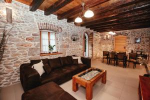 a living room with a couch and a table at Villa Romantika Dalmacija in Nin