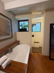 a bathroom with a large white tub in a room at Rodavento Valle de Bravo in Valle de Bravo