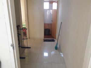 a hallway with a tile floor with a mop at Villa Venesia Berastagi Resort in Berastagi