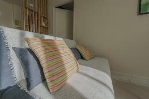 a couch with pillows on it in a living room at Cocon en Chartreuse in Voreppe