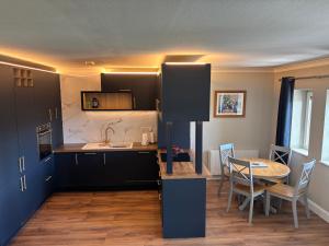 a kitchen and dining room with a table and chairs at Harbour Mill Apartment in Westport