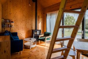 a living room with a blue couch and a ladder at Hyttee in Bardo