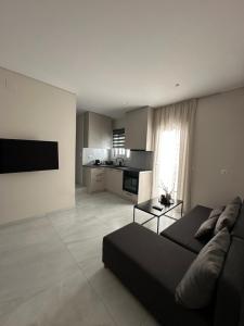 a living room with a couch and a kitchen at Kostas apartaments in Korinthos +3 photos