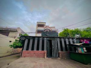 a black gate in front of a house at Gaurav Boarding House in Mathura +10 photos