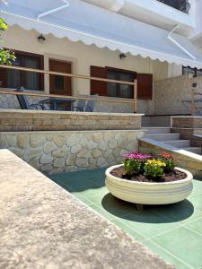 a building with a planter with flowers in it at Thalassa in Siviri