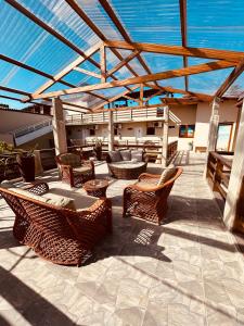 a patio with chairs and tables on a roof at Pousada Sereias de Maragogi in Ponta do Mangue