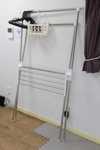a metal stand with a shelf in a room at Orange Stay Matsuyama in Matsuyama +32 photos
