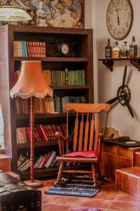 a chair and a lamp in front of a book shelf at Green Garden Plitvice lakes in Plitvica Selo