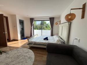 a living room with a bed and a couch at Lisa House Phu Quoc in Phú Quốc +17 photos