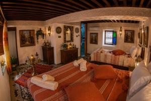 a living room with a couch and a bed at Riad T-A-J Fès Crown in Fez