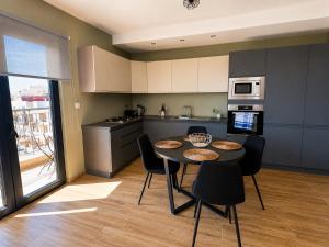 a kitchen with a table and chairs in a room at Marsascala St Thomas bay in Marsaskala