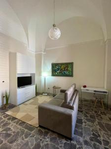 a living room with a couch and a television at Domus Solis Salento in Campi Salentina