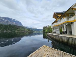 a view of a river next to a building at Huset ved Dalsfjorden in Helle