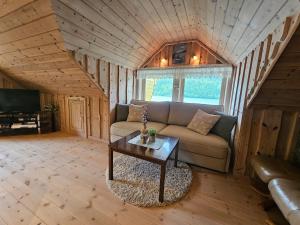 a living room with a couch and a table at Huset ved Dalsfjorden in Helle