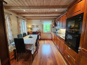 a kitchen with a table with chairs and a kitchen with at Huset ved Dalsfjorden in Helle
