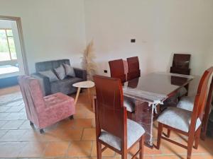 a living room with a table and chairs and a couch at Oasis Campestre in Sáchica +2 photos
