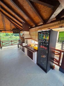 a kitchen with a refrigerator with drinks in it at Apartmani ODMOR NA DRINI in Ljubovija