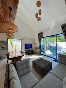 a living room with a couch and a table at Lisa House Phu Quoc in Phú Quốc