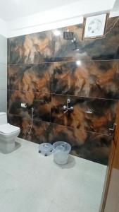 a bathroom with a sink and a toilet at Bluemoon Stay in Uttarkāshi