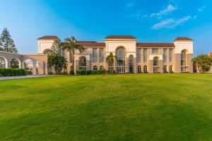 a large mansion with a large grass yard at Ranveer The Garden Resort in Haldwāni