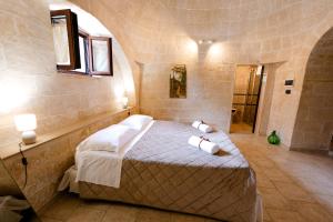 a bedroom with a bed with towels on it at Masseria La Vecchia Lamia in San Vito dei Normanni +95 photos