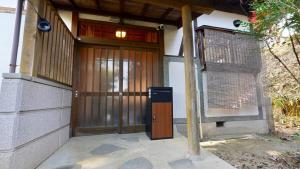 a entrance to a building with a wooden door at Serene Hill Retreat in Nakatsugawa