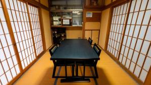 a conference room with a table and chairs and windows at Serene Hill Retreat in Nakatsugawa