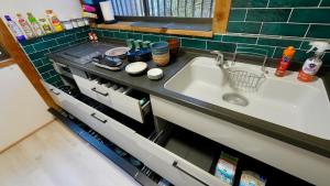a kitchen counter with a sink in a kitchen at Serene Hill Retreat in Nakatsugawa +26 photos