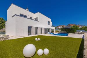 a house with three eggs on the lawn at Villa SIA with private pool in Krk
