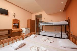two bunk beds in a room with a mirror at Qyra Studios in Skala Rachoniou
