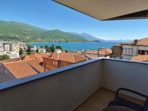 a room with a balcony with a view of the water at Villa Bella in Ohrid
