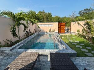 a swimming pool in the backyard of a house at Lisa House Phu Quoc in Phú Quốc