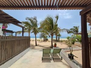 a patio with chairs and a view of the beach at Vilas Praia de Chaves SEA VIEW sol y mar in Rabil