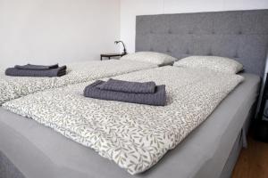 a bed with two pillows on top of it at The white Nest Apartment AC & Balcony in Bratislava