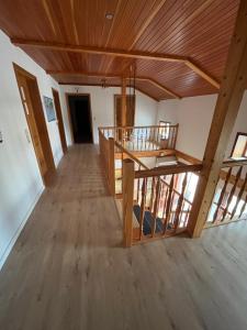 a large room with wooden floors and a wooden ceiling at Helles 2 Bettzimmer in Jerrishoe +3 photos