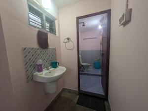 a small bathroom with a sink and a toilet at Eons riverdale in Kottayam +7 photos