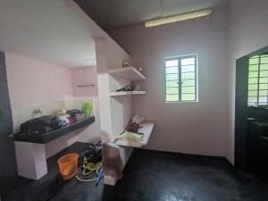 a room with a sink and a window at Eons riverdale in Kottayam