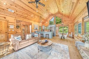 a living room with a couch and a table at Twilight Pines - Dreamy Cabin w Hot Tub & optional Kids Loft in Broken Bow