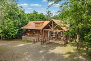 a home in the woods with a large yard at Twilight Pines - Dreamy Cabin w Hot Tub & optional Kids Loft in Broken Bow