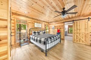 a bedroom with a bed and a ceiling fan at Twilight Pines - Dreamy Cabin w Hot Tub & optional Kids Loft in Broken Bow