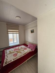 a bedroom with a large bed in a room at Bereke guest house in Bokonbayevo