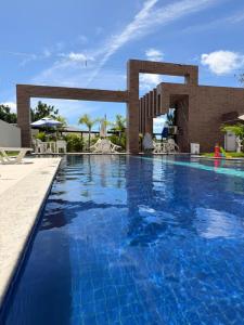 a pool at a resort with blue water at Condomínio Club Resort 2 quartos com ar na melhor da Aruana in Aracaju