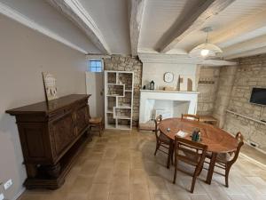 a living room with a table and a fireplace at Les Remparts T2 et T3 2 Etoiles in La Roche-Posay