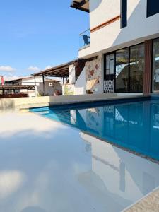 a swimming pool in front of a house at Villa Matilde in Curití